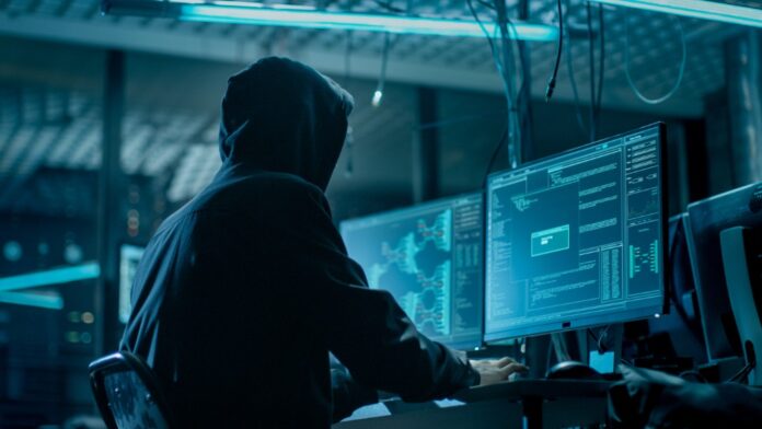 cybercriminal sitting at workstation